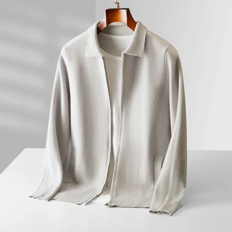 A light beige open-front knit cardigan with a collar and long sleeves, displayed on a hanger over a white top against a clean white background.