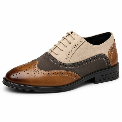 A men's three-tone wingtip oxford shoe with a brown leather toe, a dark brown suede panel, and a beige suede upper, shown on a white background.