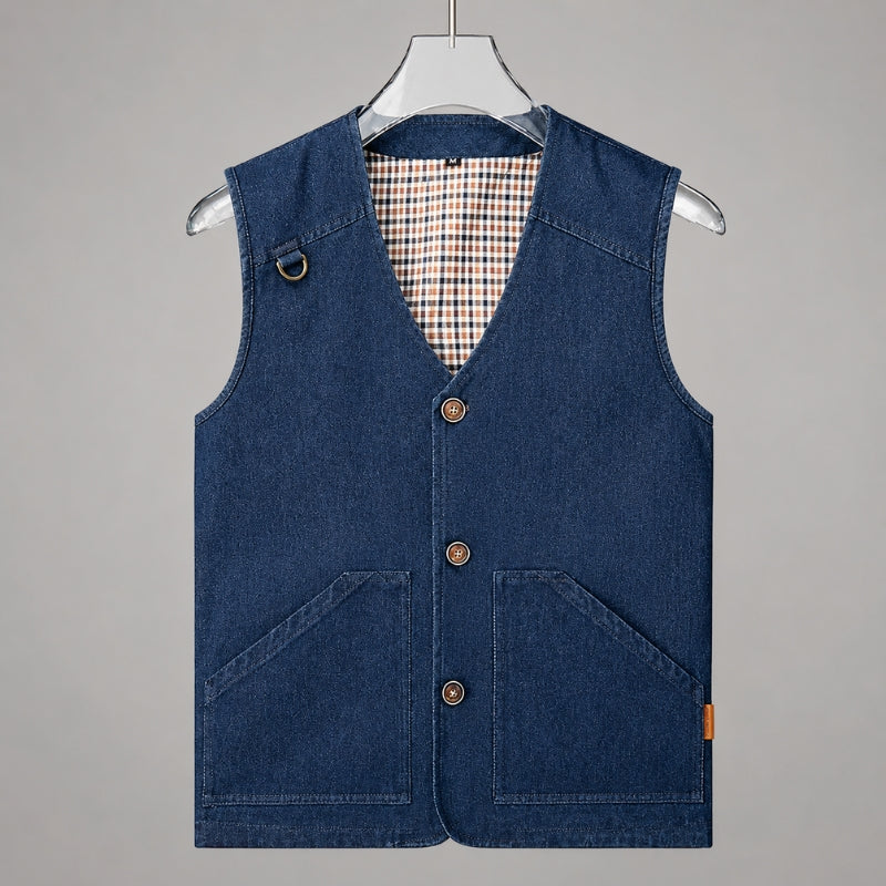 A dark blue denim vest with a V-neck, three button closures, and two large front patch pockets, hanging on a clear plastic hanger against a solid gray background.