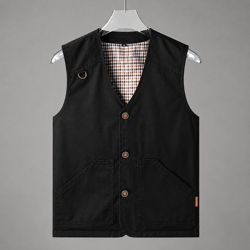 A black sleeveless vest with a V-neck, three brown buttons, and two front patch pockets, hanging on a white hanger against a solid gray background.