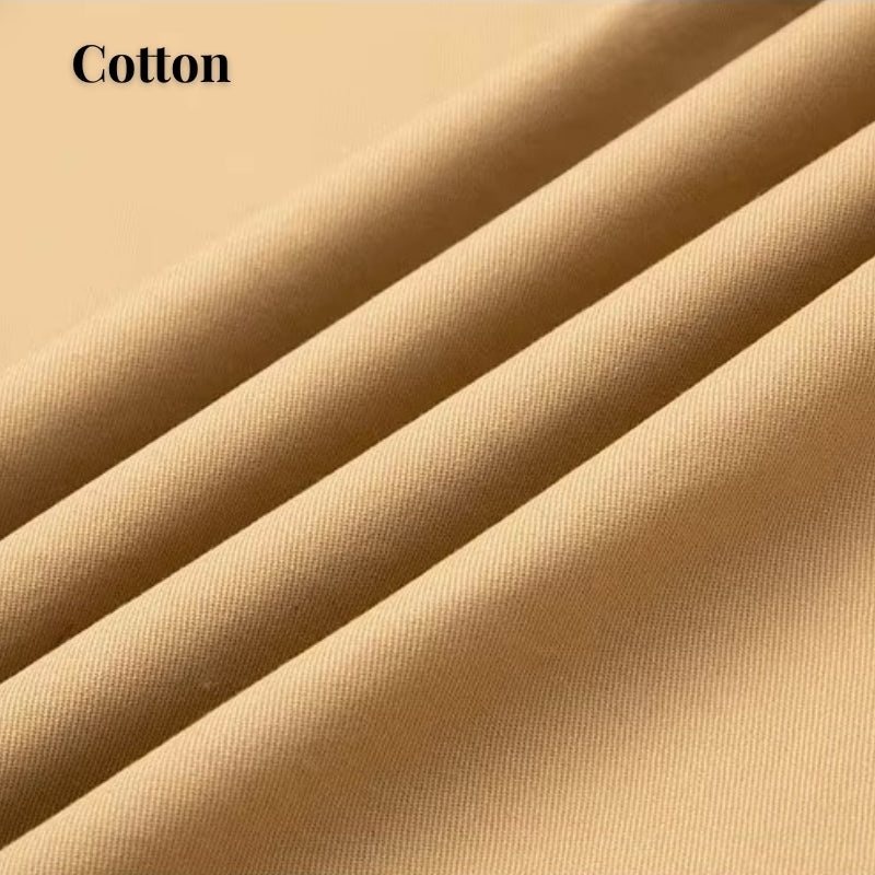 Close-up of draped beige cotton fabric with soft folds and the word 'Cotton' in the top left corner.