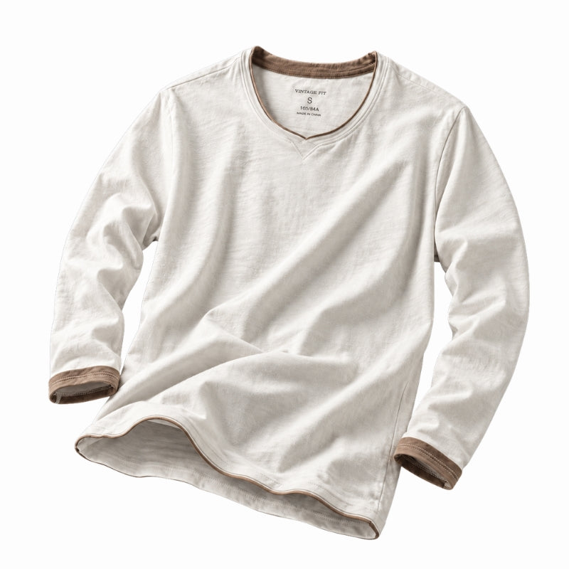 A long-sleeve V-neck t-shirt in off-white cotton-linen fabric, featuring contrasting brown ribbed trim at the collar, cuffs, and hem, displayed on a clean white background.