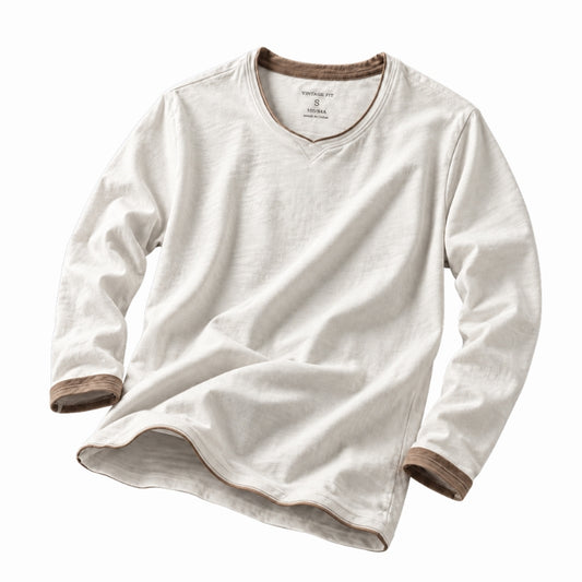 A long-sleeve V-neck t-shirt in off-white cotton-linen fabric, featuring contrasting brown ribbed trim at the collar, cuffs, and hem, displayed on a clean white background.