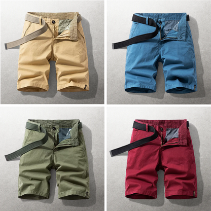 Four pairs of shorts in beige, blue, green, and red on a gray background.