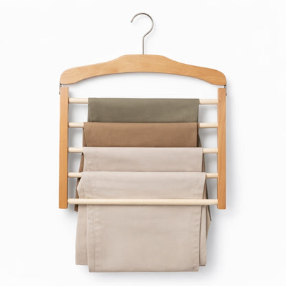 Wooden hanger with multiple shelves holding folded pants on a white background
