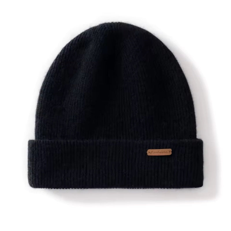 Black beanie with a brand label on a white background
