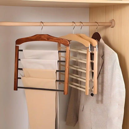 Wooden hangers with multiple hooks on a wooden rod in a closet.