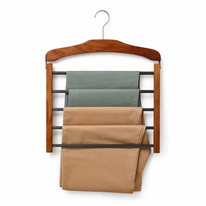 Wooden hanger with multiple shelves holding folded pants on a white background