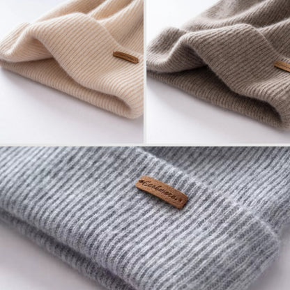Three folded knitted beans with Cashmere labels on a white background