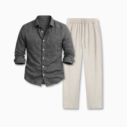 Gray button-up shirt with rolled-up sleeves on a neutral background and beige linen pants
