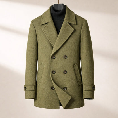 Green peacoat on a hanger against a neutral background