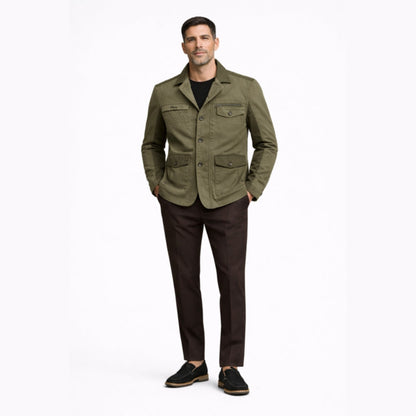 Man wearing a green jacket and brown pants on a white background