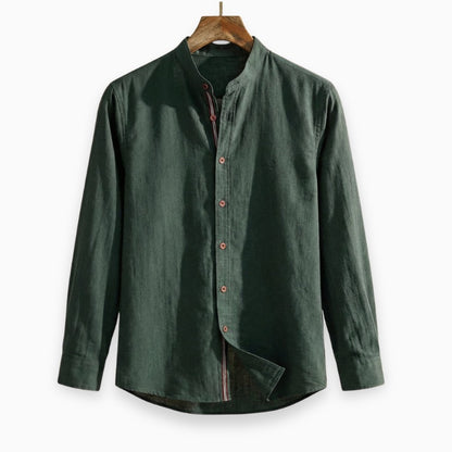 Green shirt on a wooden hanger against a white background