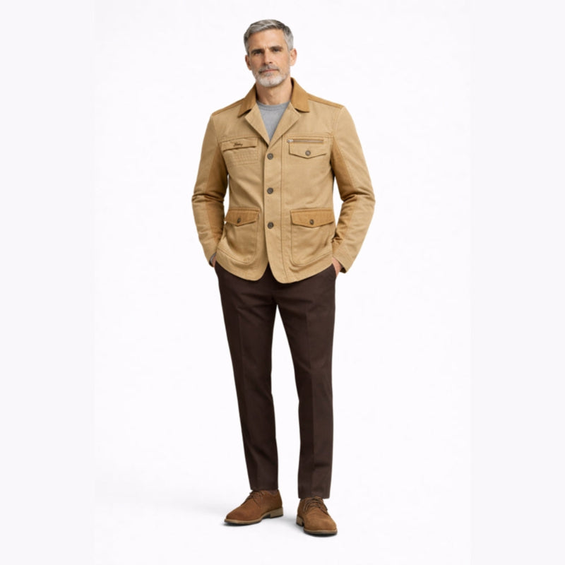 Man wearing a beige jacket and brown pants on a white background