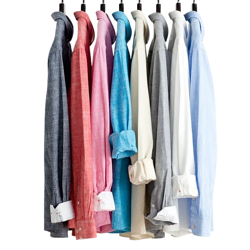 Row of colorful shirts hanging on a rack against a white background
