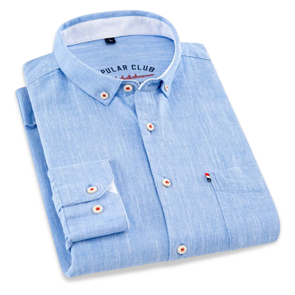 Folded light blue shirt with brand label on a white background