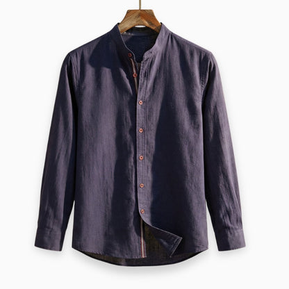 Navy blue button-up shirt on a wooden hanger against a white background