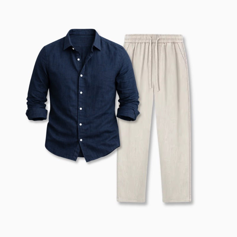 Navy blue button-up shirt with rolled-up sleeves on a neutral background and beige linen pants
