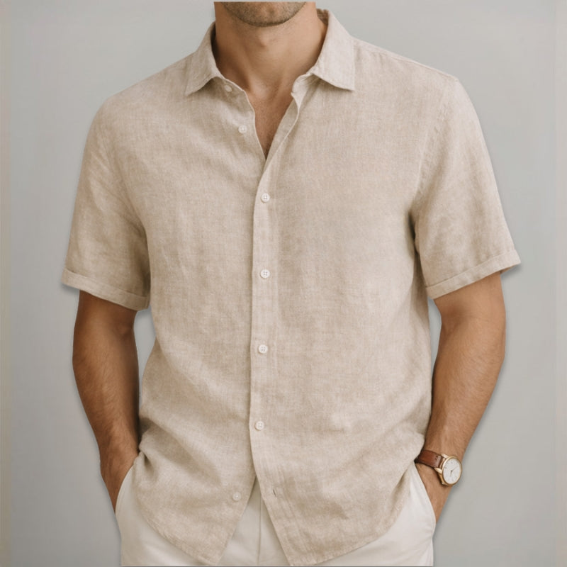 Man wearing a beige linen shirt against a gray background