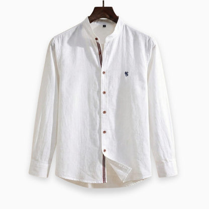 White shirt with brown buttons on a wooden hanger against a white background