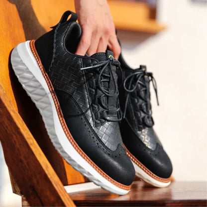Black Bruno Ridge Leather Sneakers placed on wooden stairs, modern woven leather with brown edge and soft insole