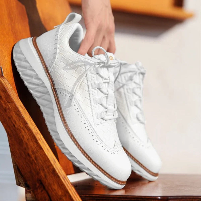 White Bruno Ridge Leather Sneakers on wooden background, premium woven leather with lightweight white sole