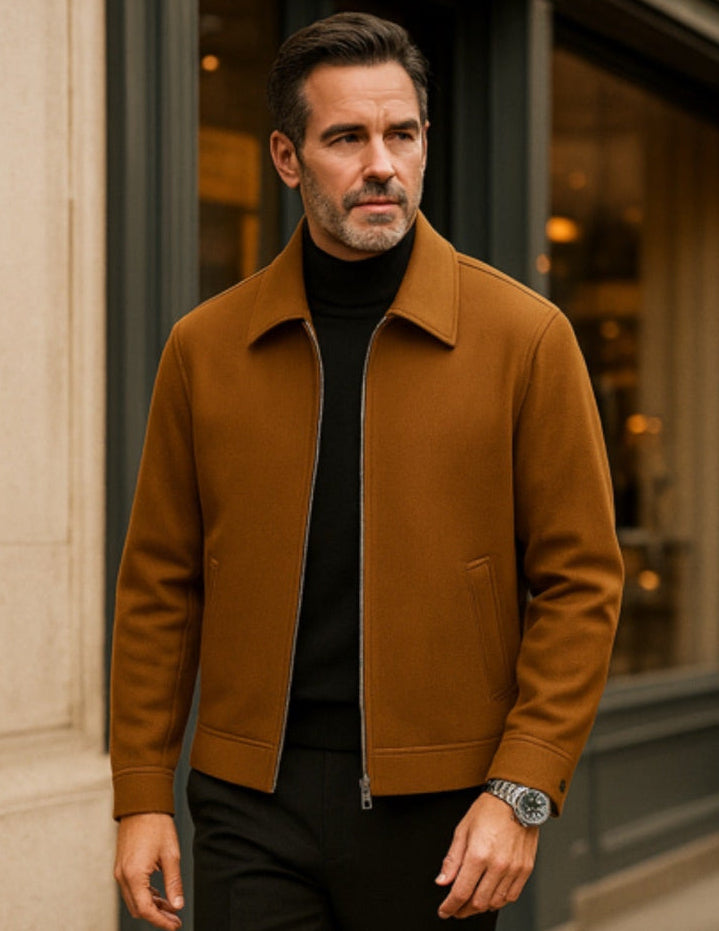 Camel city wool jacket by Polumi worn over a black turtleneck with smart black trousers. Classic menswear layering for timeless elegance in a luxury city street backdrop.