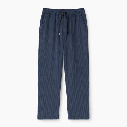 Emanuele Corduroy Pants in blue – men's ribbed corduroy trousers with drawstring waist, displayed flat on white background by Polumi.