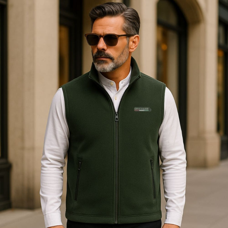 Man wearing Enrico Fleece Vest in Green with white long-sleeve shirt standing in the city