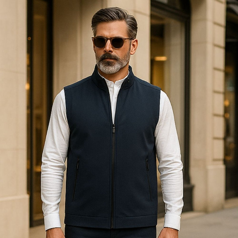 Man wearing Fabio Solid Zipper Vest in Navy paired with a white shirt on the street