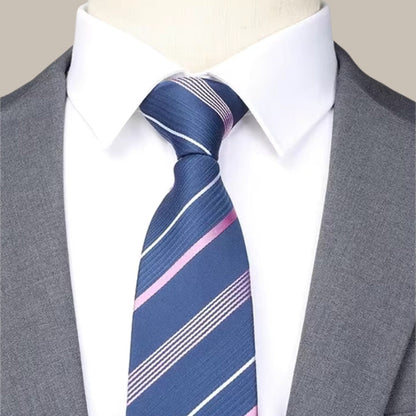 Close-up detail of Firenze gray suit with striped blue tie and crisp white shirt, highlighting refined craftsmanship and timeless elegance.