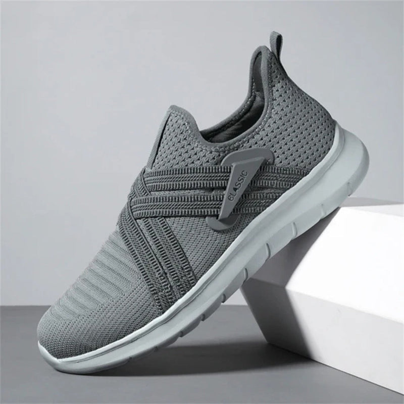 Gray Francesco Premium X Sneakers featuring cross strap design and cushioned sole for comfort and everyday wear