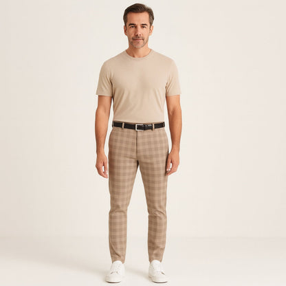 Model wearing Giacomo Timeless Check Pants in beige with matching T-shirt, black belt, and white sneakers – Polumi elegant men’s fashion.