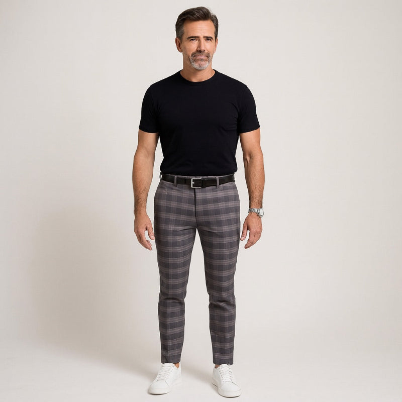 Model wearing Giacomo Timeless Check Pants in gray with black T-shirt, black belt, and white sneakers – Polumi modern men’s fashion.