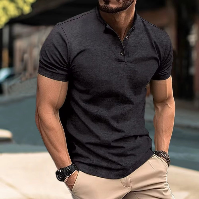 Man wearing black Henley T-shirt with button placket – casual street style outfit.