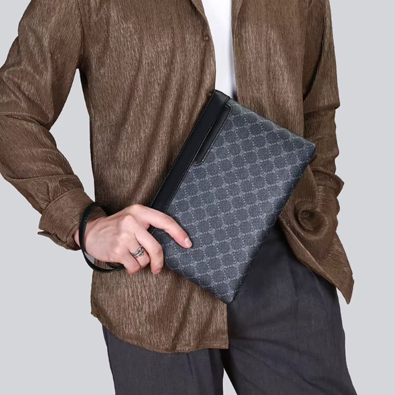 Men’s fashion outfit holding a stylish black leather clutch bag.