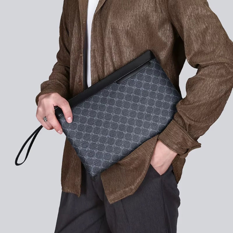 Man carrying black leather clutch bag with wrist strap in casual outfit.