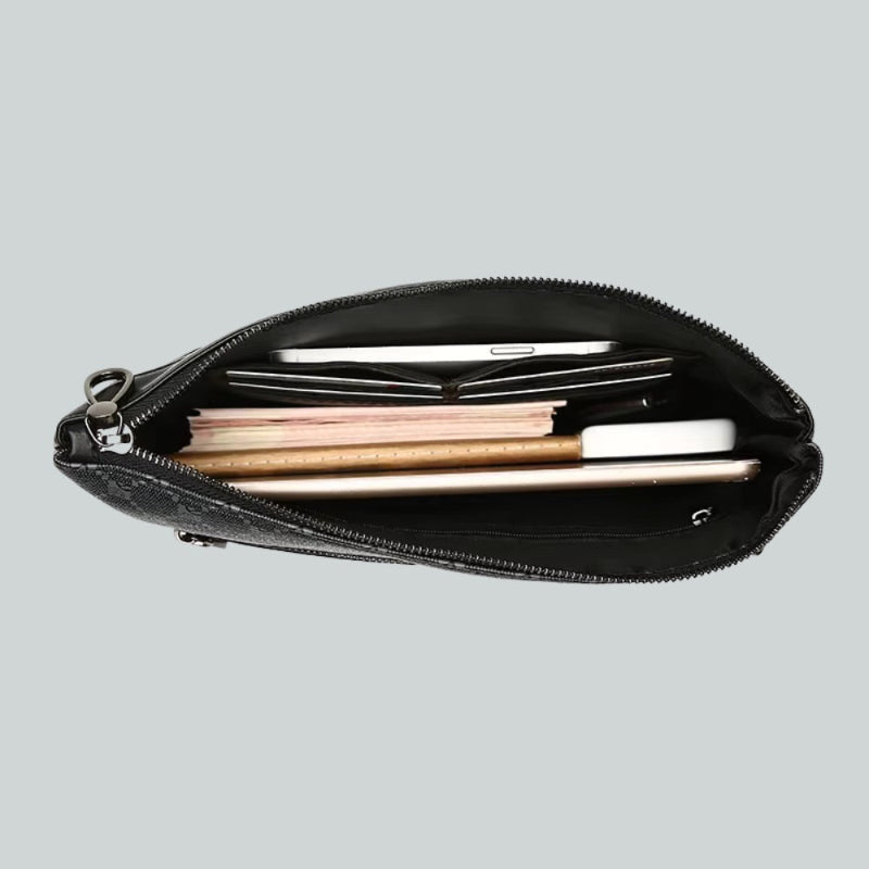 Open black leather clutch bag filled with phone, wallet, and documents.