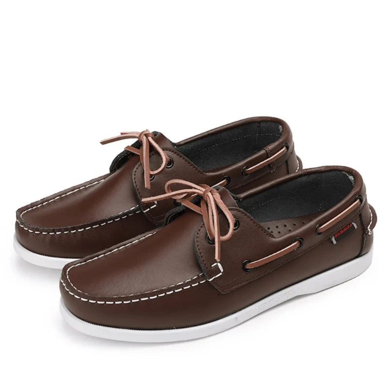 Pair of men’s leather boat shoes in brown with contrast stitching and pink laces, classic casual moccasins for summer outfits