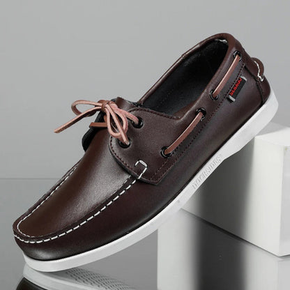 Men’s leather boat shoes in brown with white sole and contrast stitching, premium casual moccasins for summer and travel.
