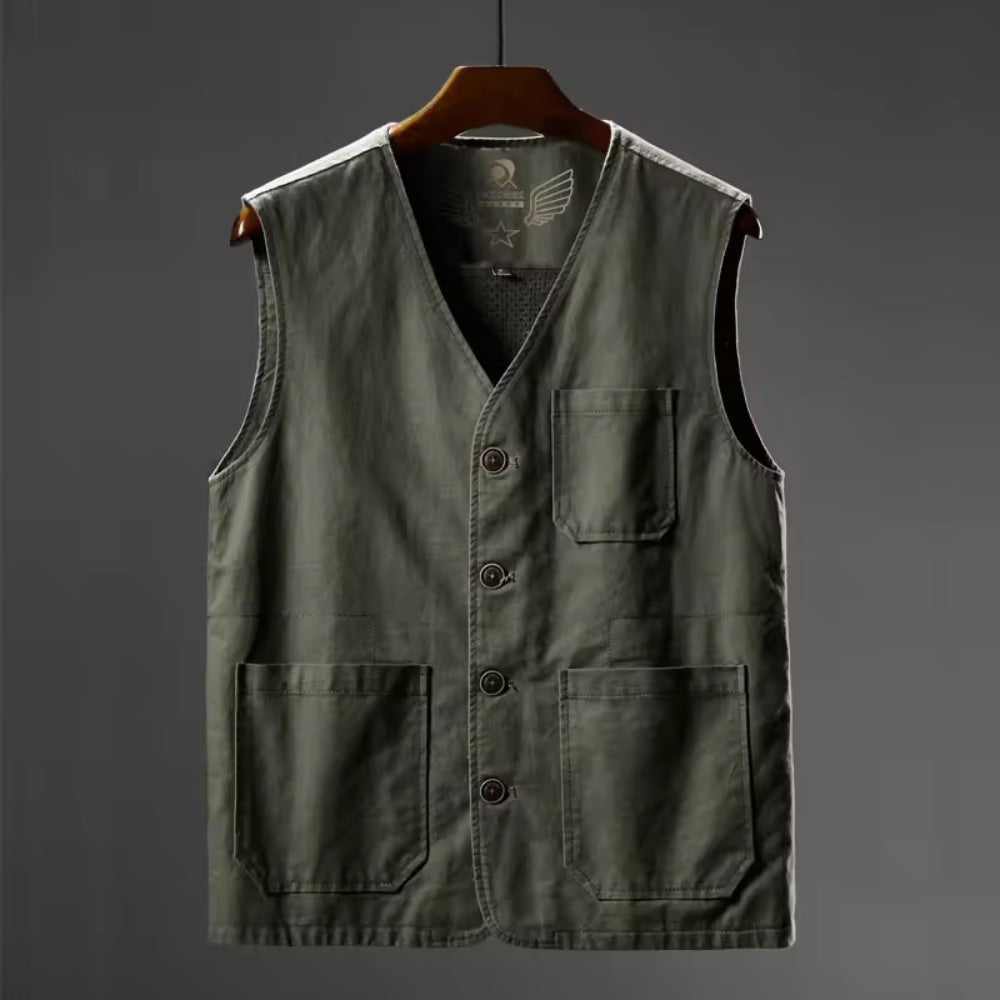Green vest with buttons on a hanger against a gray background