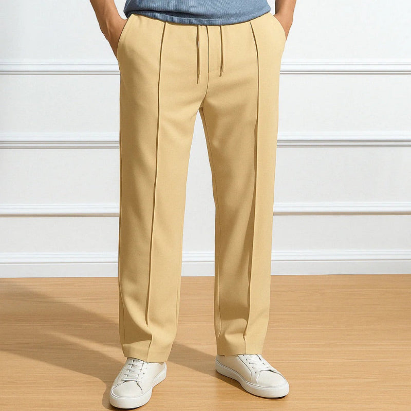 Men’s beige relaxed fit trousers with straight cut, crease detail and elastic drawstring waist.