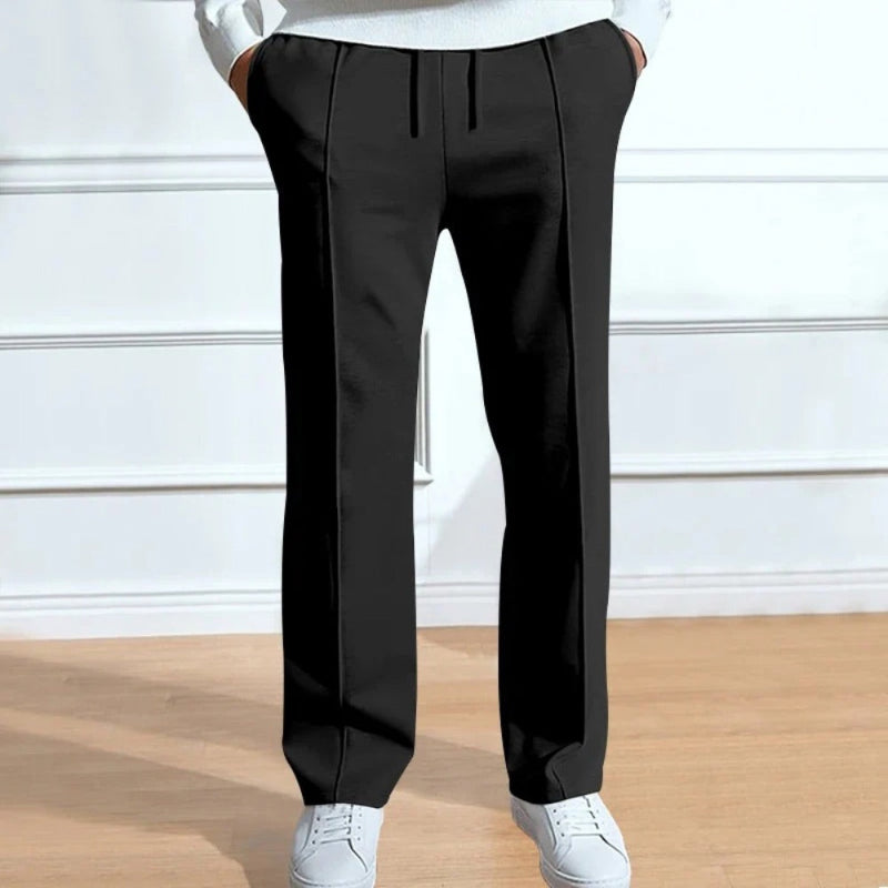 Men’s black relaxed fit trousers with crease detailing and adjustable drawstring waist.