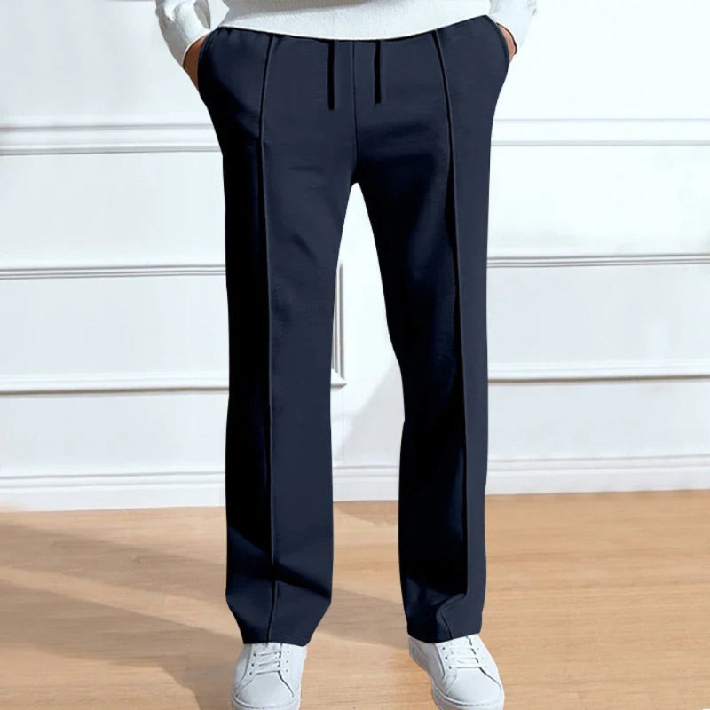 Men’s navy blue trousers with relaxed fit, front crease lines and drawstring closure for comfort.