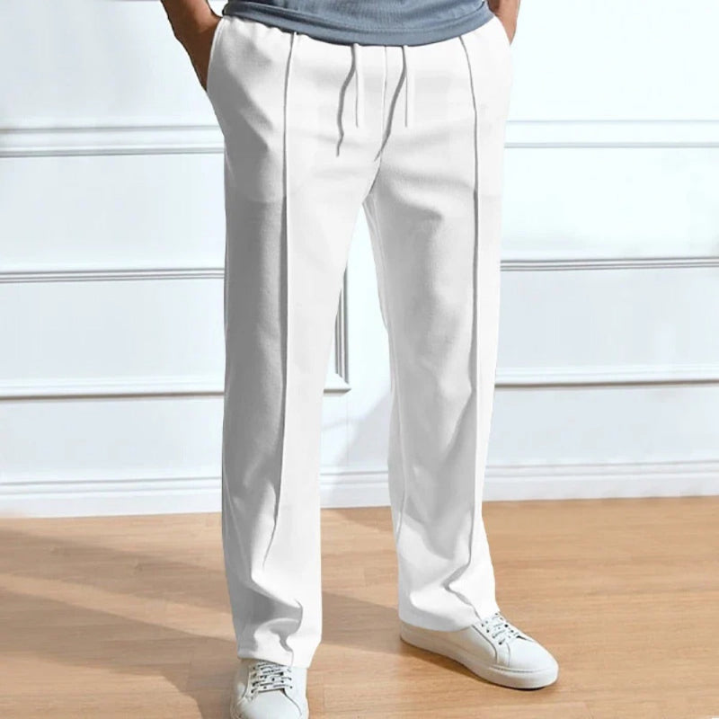 Men’s relaxed fit trousers in white with front crease, drawstring waist and straight leg design.