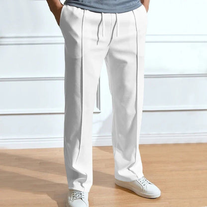 Men’s relaxed fit trousers in white with front crease, drawstring waist and straight leg design.