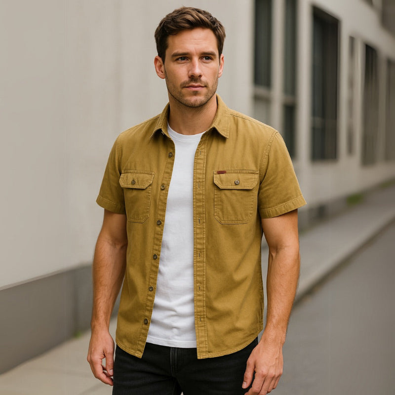 Model wearing mustard yellow men’s short sleeve casual shirt paired with black pants.