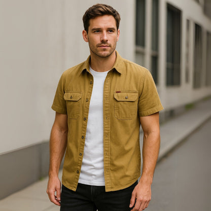 Model wearing mustard yellow men’s short sleeve casual shirt paired with black pants.