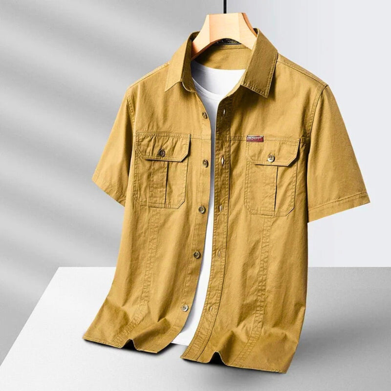 Men’s short sleeve casual shirt in mustard yellow with button front and chest pockets.