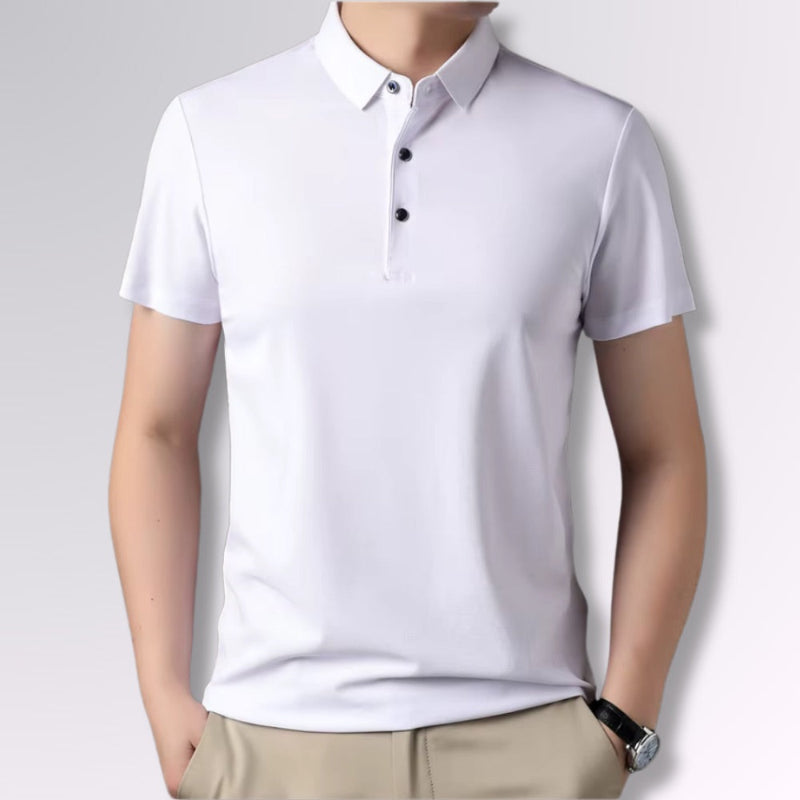 Men’s white polo shirt short sleeves, button placket, worn by model with beige pants.